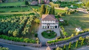A large, two-story house with a symmetrical facade, a central entrance, and a well-maintained garden. - Villa Near Lucca With Tuscan Garden Views (Capannori)