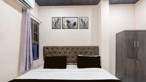 A bedroom with a bed, a headboard, a wardrobe, and three framed artworks on the wall. - Super Hotel Buddheshwar Temple Lucknow (Lucknow)