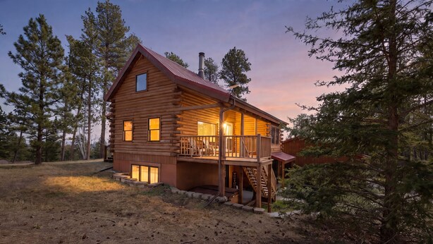 A log cabin with a balcony, a chimney, and a porch. - Hilltop Log Cabin Retreat with Hot Tub & Direct Trail Access Near Lead (Lead)