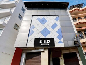 A hotel with a modern facade, a prominent sign, and a balcony with a railing. - Saver Double OYO Hotel O Sankat Mochan (Varanasi)
