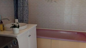 A bathroom with a sink, a toilet, a washing machine, and a bathtub. - Private Room in a Shared Flat - Lyon 8 e (Lyon)