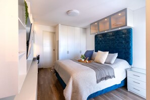 A bedroom with a bed, a bedside table, a wardrobe, and a built-in cabinet. - Luxury apartment, in Gastronomic zone, 5 minutes from Mira. (Lima)