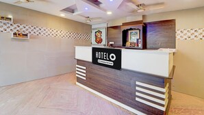 A hotel reception desk with a sign reading 'HOTELO Company Serviced.' - Super Hotel O Anna Nagar Madurai (Madurai)