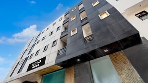 A multi-story hotel with a modern design, featuring balconies, large windows, and a prominent 'HOTEL' sign. - Saver Single Hotel Chhillar Inn (New Delhi)