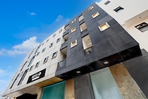 A multi-story hotel with a modern design, featuring balconies, large windows, and a prominent 'HOTEL' sign. - Saver Single Hotel Chhillar Inn (New Delhi)