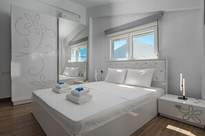 Quarto moderno com uma cama grande, um guarda-roupa, uma mesa de cabeceira com abajur e uma janela.