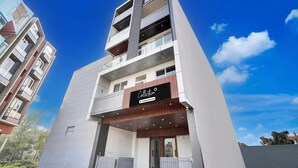 A modern multi-story building with a prominent sign reading 'Collection.' - Classic With Balcony Surajpur Greater Noida (Greater Noida)