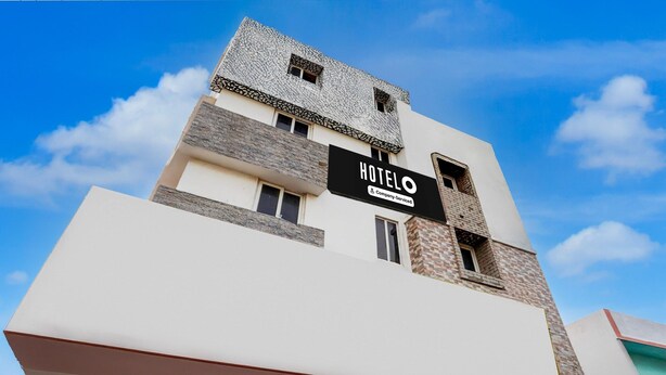 A modern hotel building with a sign reading 'HOTELO' and a company-serviced logo. - Suite Super Hotel O Anna Nagar Madurai (Madurai)