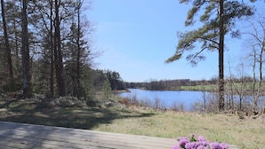A wooden deck with a view of a lake and trees. - 4 Star Holiday Home in Skanes-fagerhult (Skånes Fagerhult)