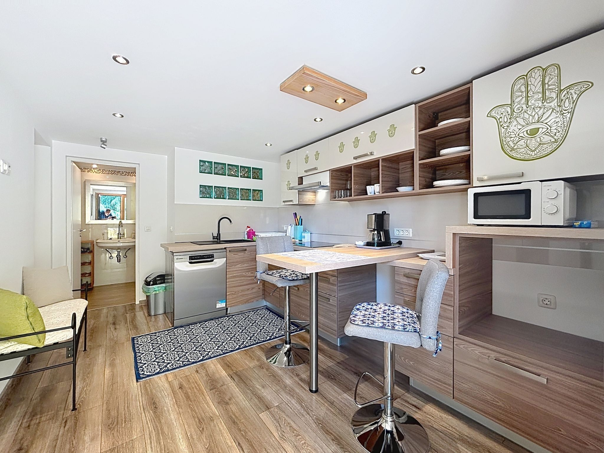 A compact kitchen with a central island, a microwave, and a coffee maker.