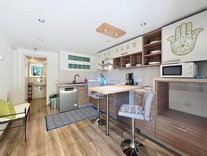 A compact kitchen with a central island, a microwave, and a coffee maker. - Apartment Adri by Interhome (Rovinj)