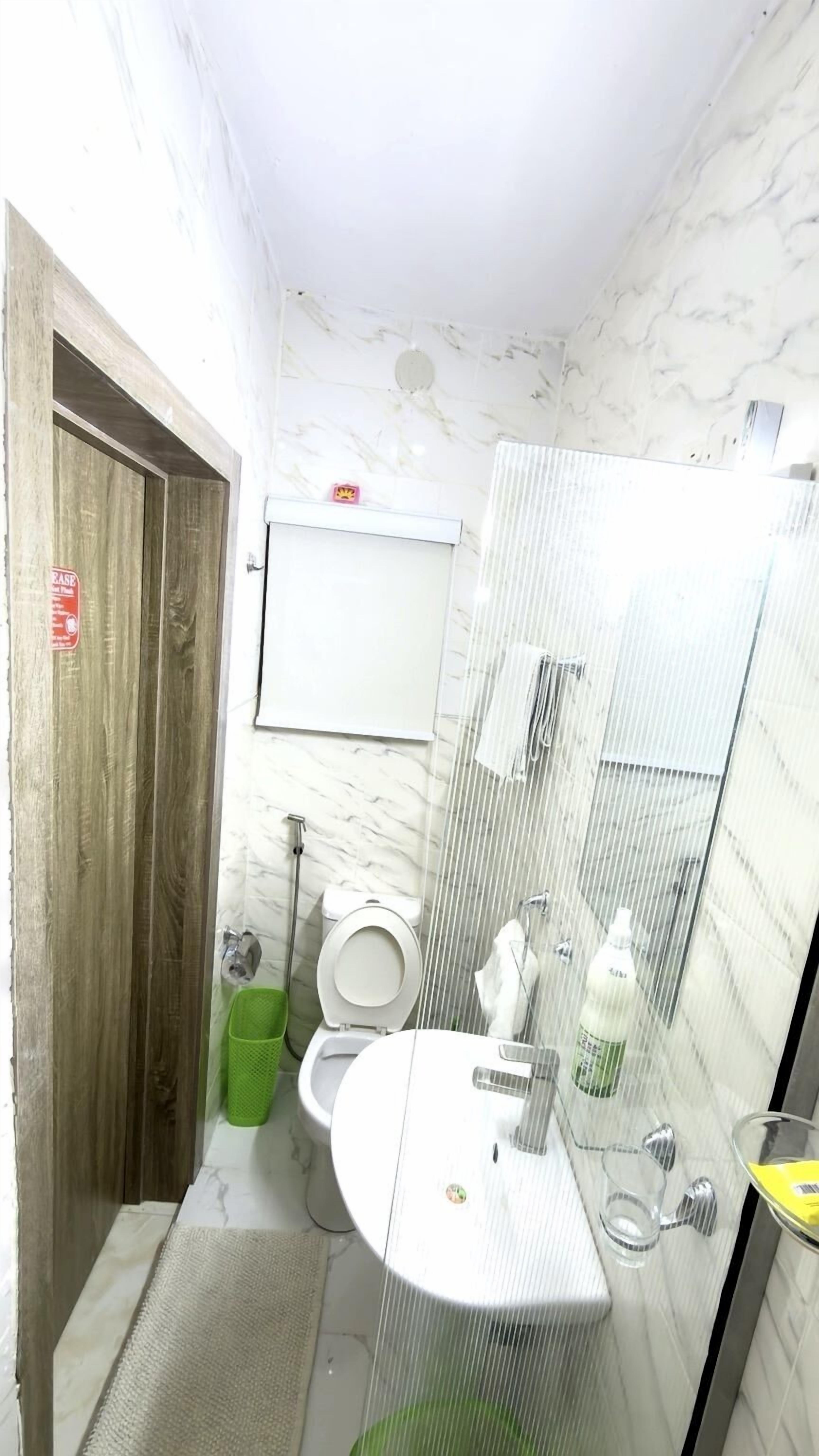 Une petite salle de bain comprenant des toilettes, un lavabo et un miroir.