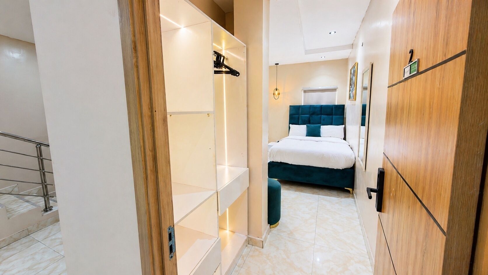 A hotel room with a bed, wardrobe, and a bathroom with a shower and toilet.
