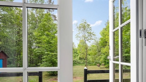 A wooden deck with a view of a forested area through large windows. - "Heda" - 1.6km to the fjord by Interhome (Hadsund)