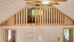 A wooden interior with a sloped ceiling, a ladder, and a window. - "Heda" - 1.6km to the fjord by Interhome (Hadsund)