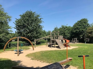A playground with swings, slides, and climbing structures. - Vacation home near the North Sea and forest. Bergen, NH, Schoorl, Schoorldam (Warmenhuizen)