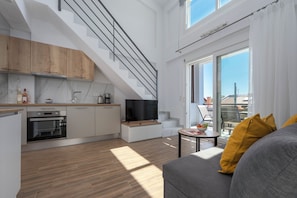 A modern apartment with a kitchen, dining area, and living room. - SLV Irida Apartment (Pangaio)