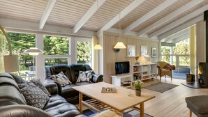 A spacious living area with a sofa, a coffee table, and a fireplace. - "Ilya" - 900m from the sea by Interhome (Løkken)
