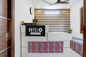 A hotel reception desk with a sign reading 'HOTEL O' and a company-serviced label. - Saver Double Hotel Prabhat (Dera Bassi)