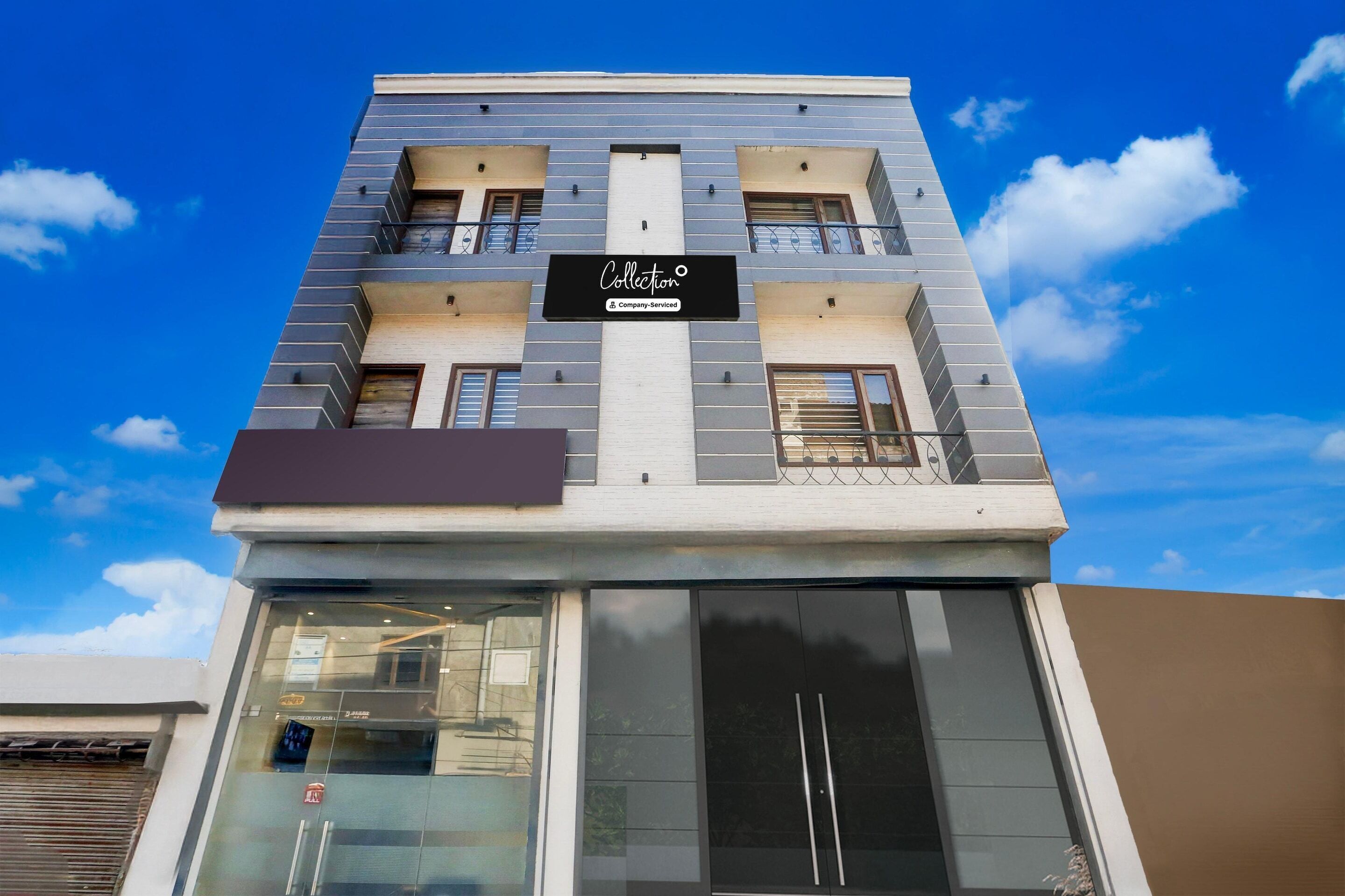 A modern building with a sign reading 'Collection & Company Services' on the facade.