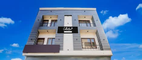 A modern building with a sign reading 'Collection & Company Services' on the facade.