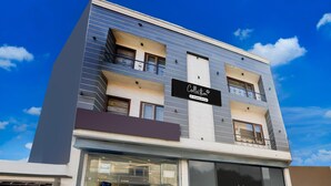 A modern building with a sign that reads 'Collection.' - Deluxe City Center Ludhiana MMC Inn (Ludhiana)