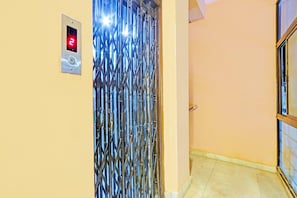 A metallic elevator door with a digital display showing the number 2.