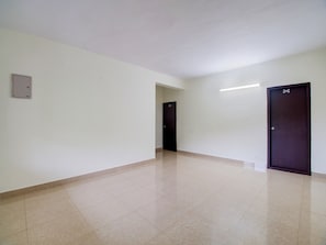 A hallway with two doors, one marked with the number 502, and a light switch on the wall.