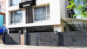 A building with a sign reading 'Townhouse' and a gated entrance. - Premium New Krish Residency (Barasat)