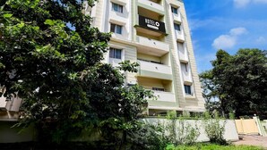 A multi-story hotel building with a sign reading 'HOTELO' and balconies. - Deluxe Sai Nivas Rushikonda (Visakhapatnam)