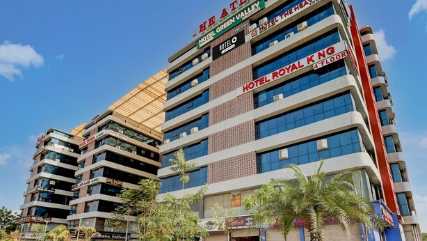 A multi-story hotel with various brands including 'Hotel Atlanta,' 'Hotel Green Valley,' and 'Hotel Royal King.' - Super Deluxe Roomnana Chiloda Near Airport (Gandhinagar)