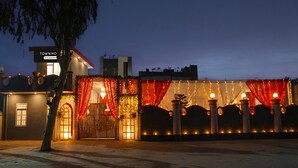 A building with a sign reading "TOWNHO" and a gated entrance. - Deluxe BSA Townhouse (Lucknow)