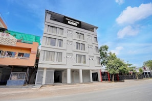 A multi-story building with a sign reading 'TOWNHOUSE OAK' and 'OYO-Serviced'.