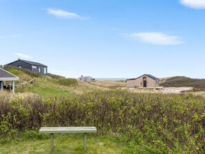 A coastal property with multiple buildings, a grassy area, and a bench. - "Alea" - 150m from the sea by Interhome (Hjørring)