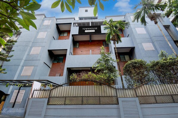 A modern townhouse with a sign reading 'TOWNHOUSE & Company Service.' - Super Townhouse Formerly Silver Crest (Pune)
