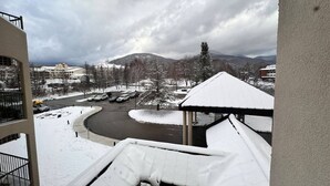 Paesaggio innevato con una strada curva, una tettoia e edifici sullo sfondo.