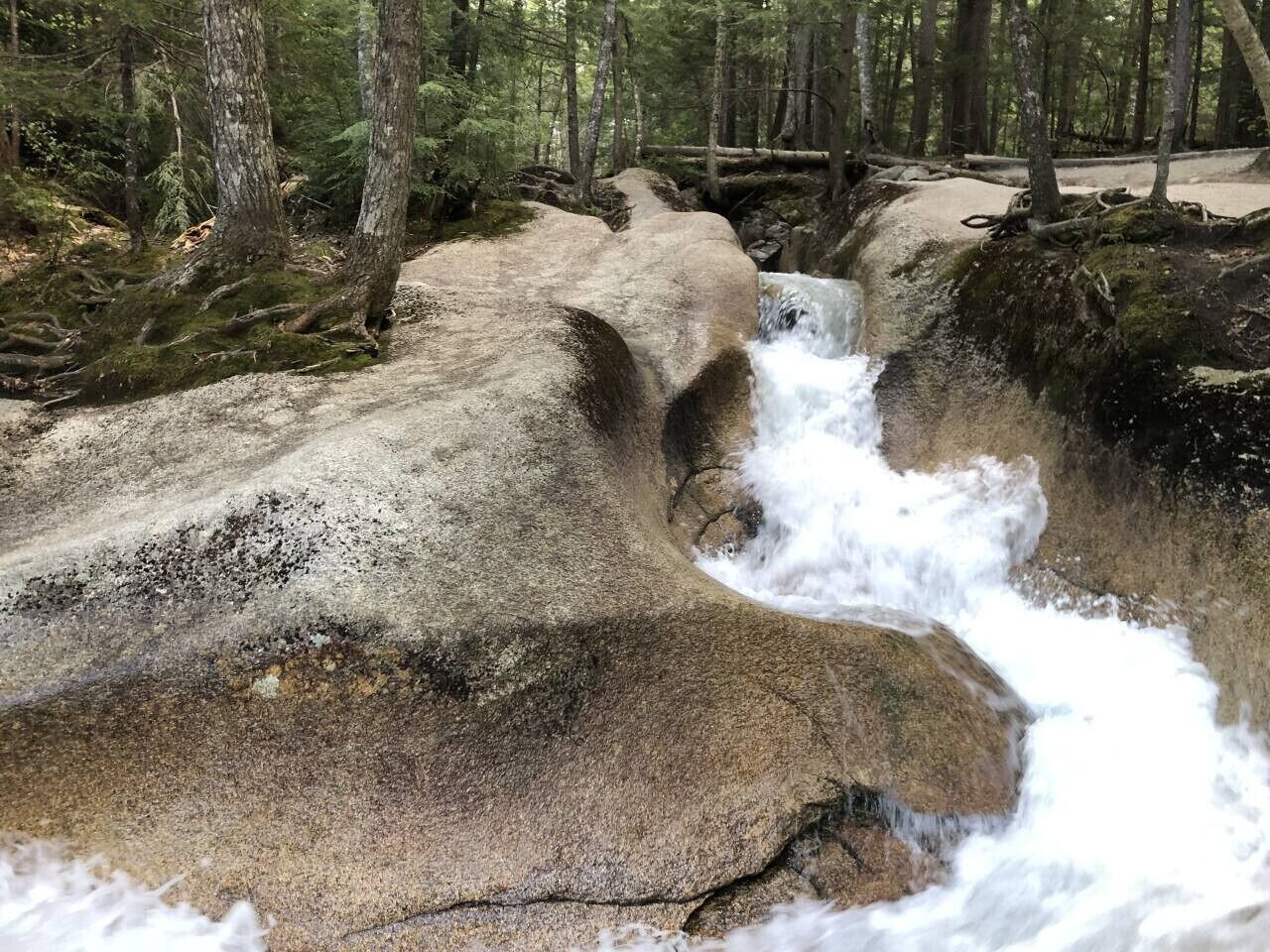 A natural rock formation with a waterfall.