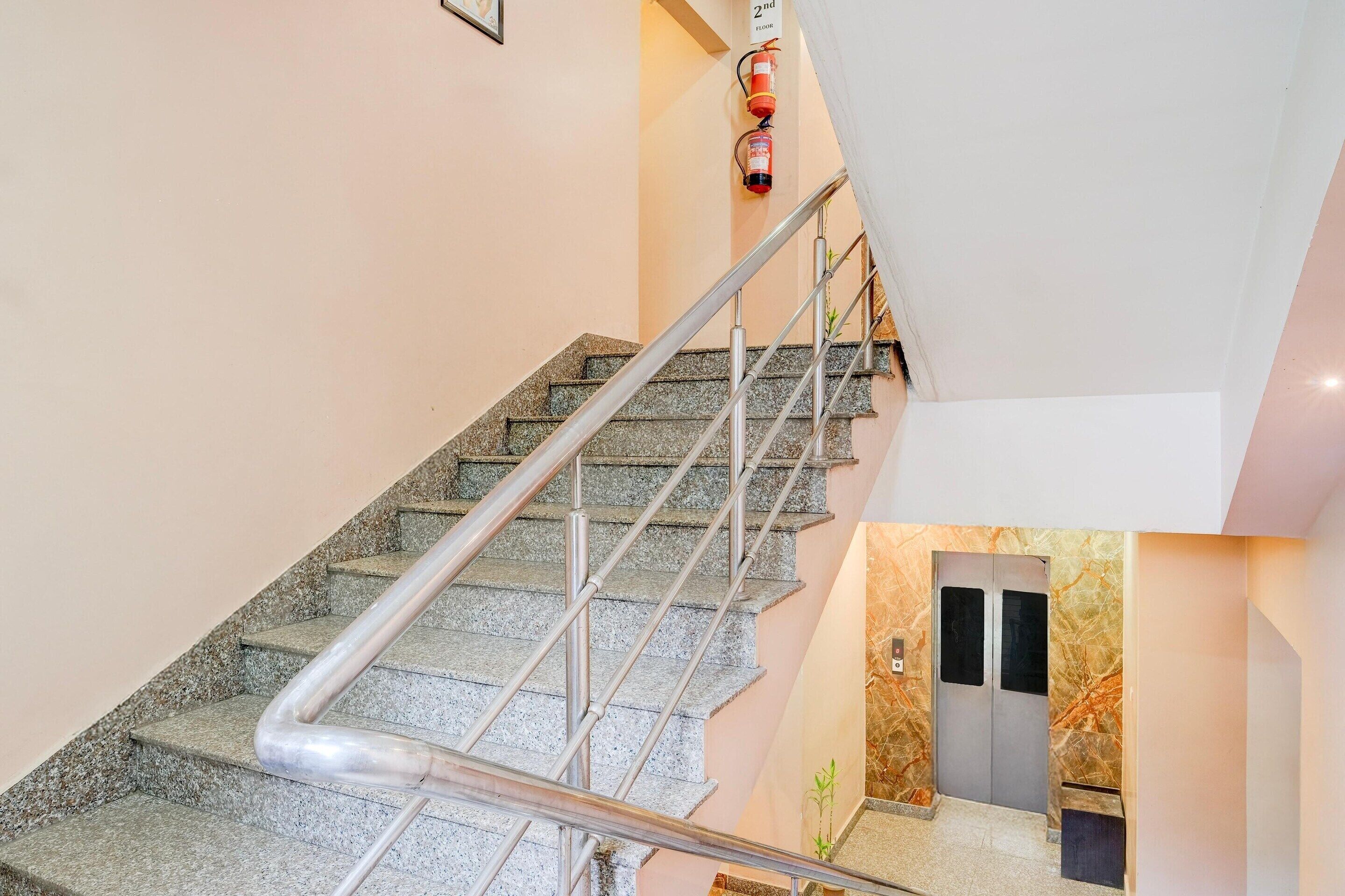 A modern staircase with metal railings and granite steps.