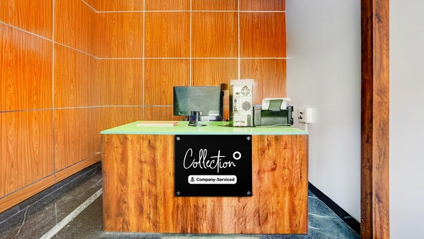 A reception desk with a sign reading 'Collection' and 'Company-Served.' - Deluxe y Stay Home Stay (Tirupati)