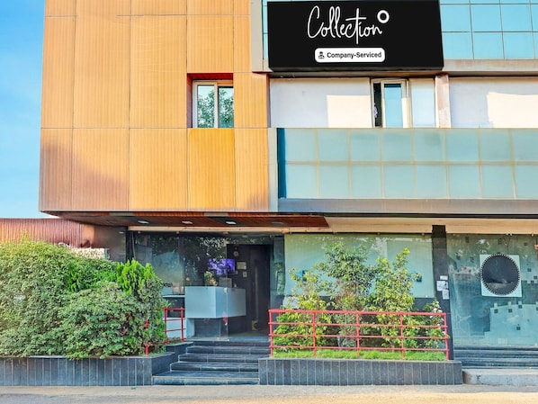 A modern building with a sign reading 'Collection Company-Serviced.'
