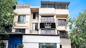 A multi-story building with a sign reading "Collection" and a company-serviced logo. - Collection O Andheri Near Mumbai Airport (Mumbai)