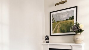 A room with a black filing cabinet, a fireplace, and a framed painting on the wall. - Raven Suite - Interconnected Room (Shropshire)