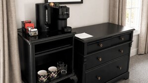 A room with a black desk, a framed picture on the wall, a window with curtains, and a carpeted floor. - Raven Suite - Interconnected Room (Shropshire)