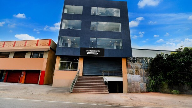 A modern building with a sign reading 'TOWNHOUSE' and a staircase leading to the entrance. - Super Townhouse Cherlapally Bus Terminal (Hyderabad)