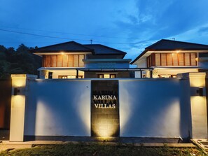 A modern villa with a prominent entrance gate labeled 'Karuna Villas.' - Bali Lovina Karuna Villa near beach (Kabupaten Buleleng)