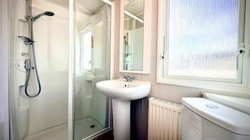 Separate bathtub and shower, deep-soaking bathtub, hair dryer, towels