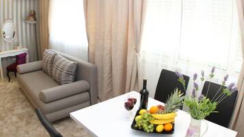 Studio (Superior Studio Apartment) | Woonkamer | Een 32-inch flatscreentelevisie met kabelzenders