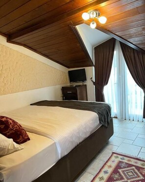 Economy Double Room, Balcony, Garden View | In-room safe, blackout curtains