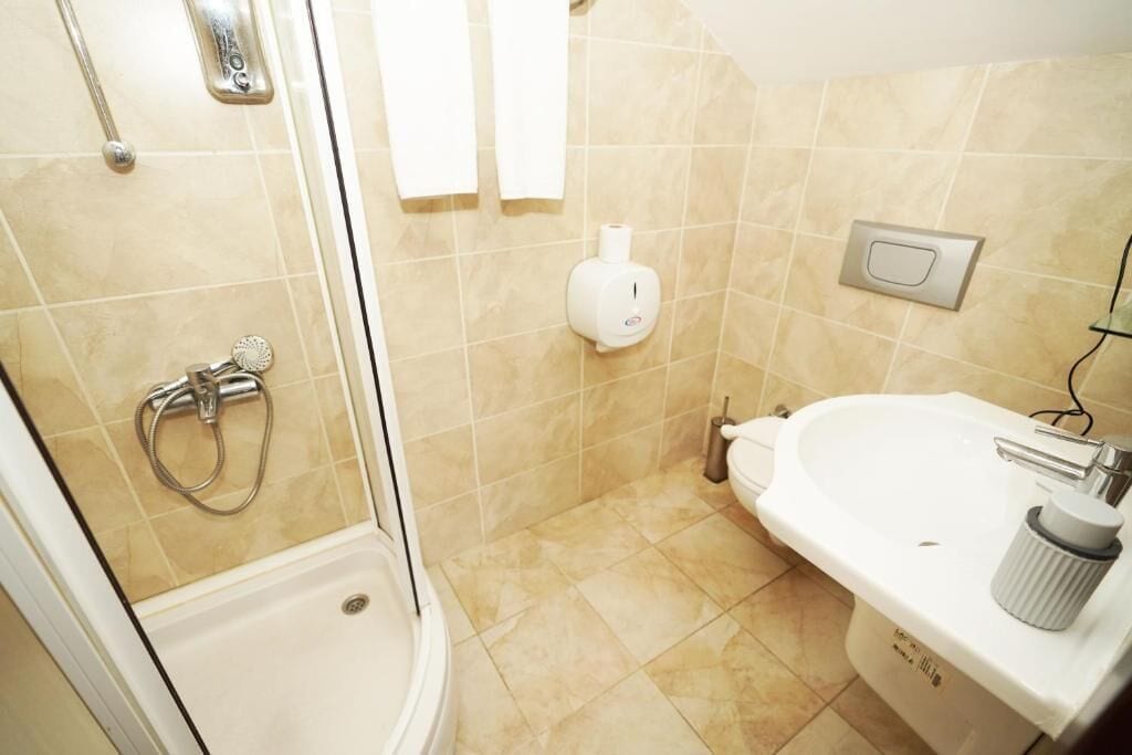 Un baño con ducha, inodoro y lavamanos.