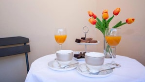 A breakfast setup with orange juice, a bowl of soup, and a small plate of cookies. - Guest House Stay & Smile Dolac Primošten (Primosten)